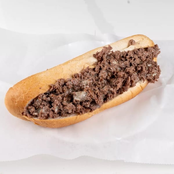 A classic cheesesteak sandwich with chopped meat and melted cheese on a long roll.